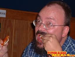 Jason Wolcott chews through a &quot;chicken leg&quot; while his eyes literally burn! - 20070123-asstastic_Wing_Challenge_II_15