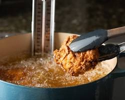 Image of Placing chicken in hot oil