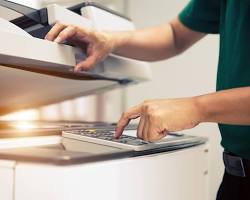 Image of person scanning a document on a photocopier