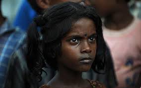 A young displaced Tamil girl looks on as David Miliband and his French counterpart Bernard Kouchner arrive in northern Sri Lanka recently Photo: (AFP: Pedro ... - Young-Tamil-Girl_1395968c
