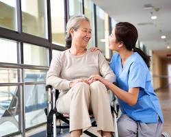 Certified Nursing Assistant (CNA) helping elderly patient