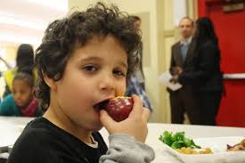 Ivan Vega, 8, takes a bite out of his favorite healthy food, an apple, during lunch at P.S. 63 in the Lower East Side of Manhattan on January 26, 2011. - img_6420