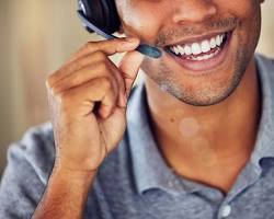 Image of Inbound call center agent wearing headset smiling
