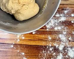 Gambar Turn the dough out onto a lightly floured surface and knead for 57 minutes
