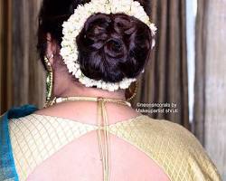 Image of Classic Bun with a Twist hairstyle for saree