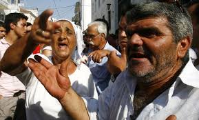 Petros Giannakouris/AP Roma people shout outside the court in Amaliada, the Peloponnese, Greece in a 2007 file photo. - image