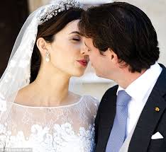 Sealed with a kiss: Prince Felix and his wife Clair pucker up for the crowds who had come to see them marry - article-2427976-1823C09500000578-623_634x583