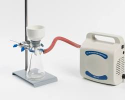 Image of Vacuum Filtration setup: A Büchner funnel with a filter paper placed over a flask connected to a vacuum pump.