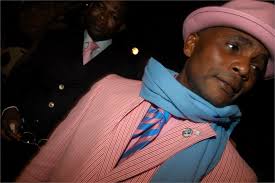 Congolese sapeur in a dapper pink pinstripe suit and hat