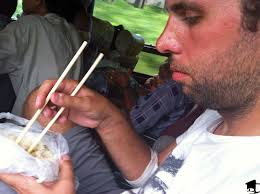 Mike tries to eat sticky rice with chopsticks on the bus. - img_8720