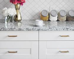 Ceramic tile backsplash in white kitchen