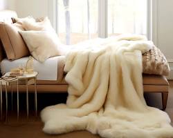 Image of living room with a faux fur throw draped over a neutraltoned sofa